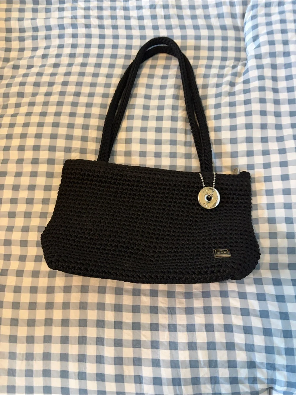 The Sak Black Crochet Shoulder Bag with Silver Circular Charm